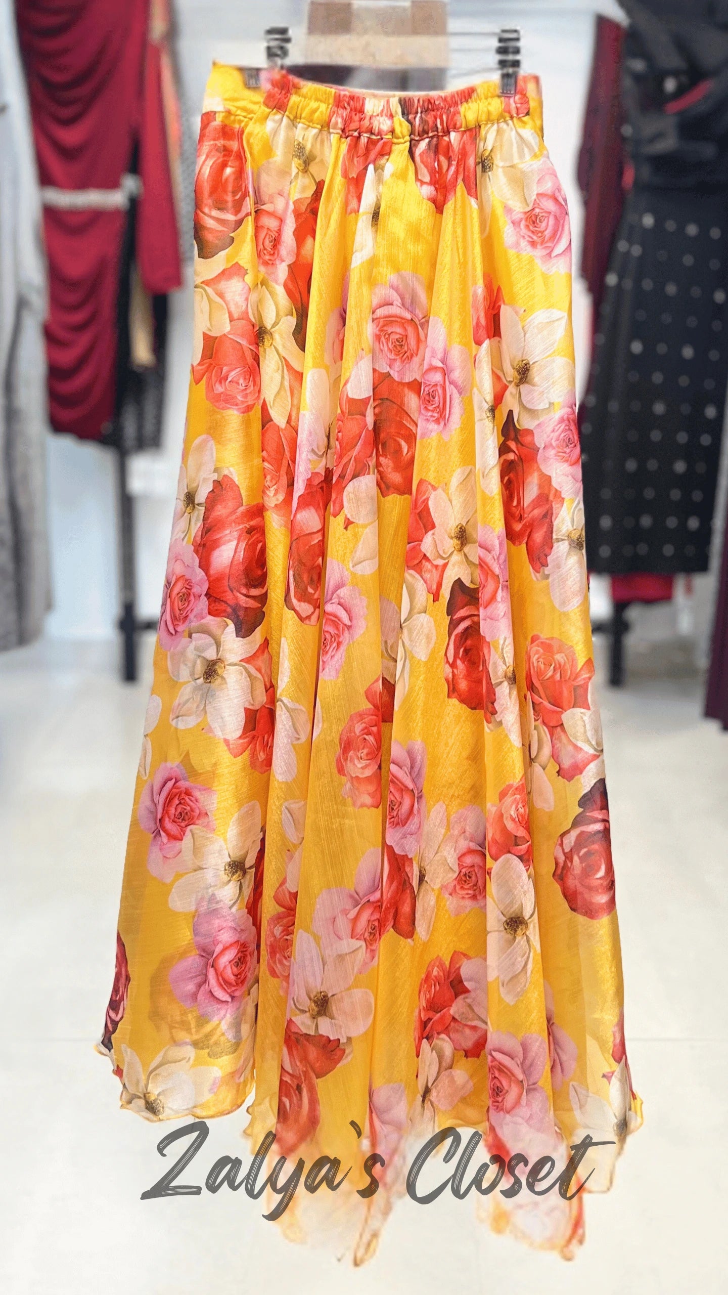 Yellow floral skirt on a mannequin with 'Zalya's Closet' branding.